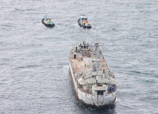 Tugboats tow the HTMS Chang from Bangkok to Koh Chang.